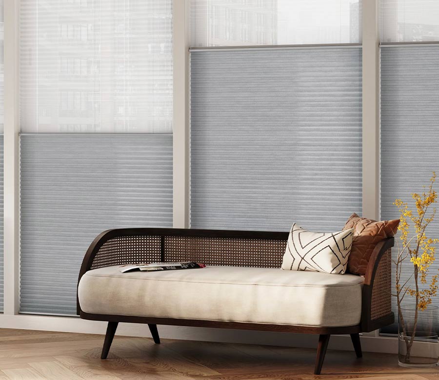 dual honeycomb shades behind a modern seat