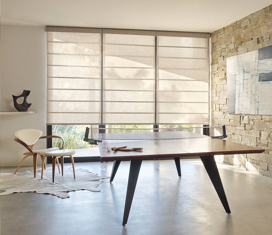 light filtering roller shades on large windows in game room