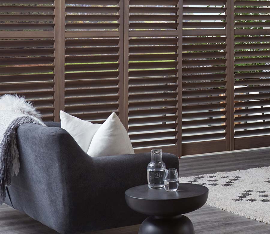 brown shutters in living room night and day