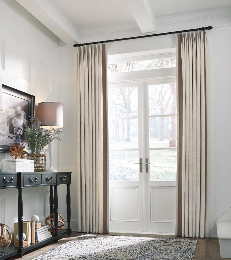 custom drapes cover french doors in Toronto home