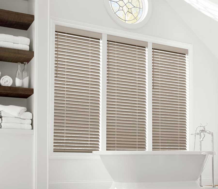 cream everwood venetian blinds above bathtub in bathroom