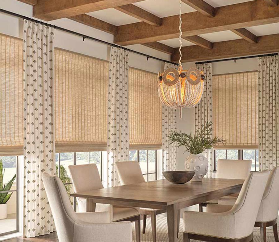 side drapery panels and window shades layered in a cozy modern dining room