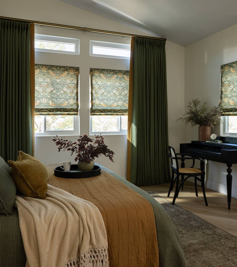 Custom Roman shades and green drapery in a Toronto bedroom