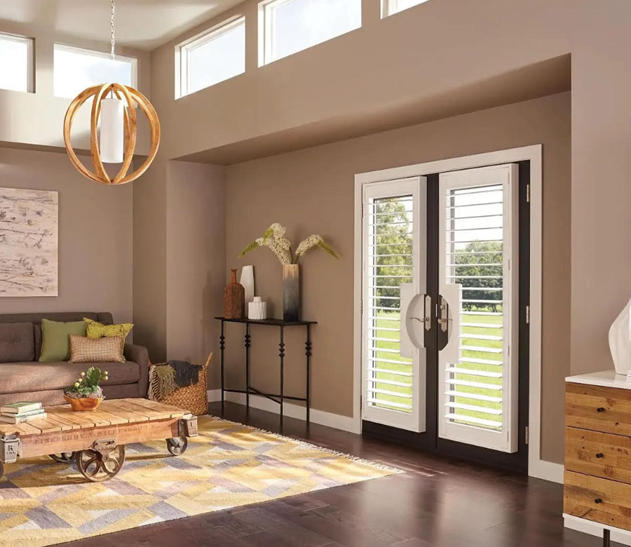living room with glass doors with eclipse shutters