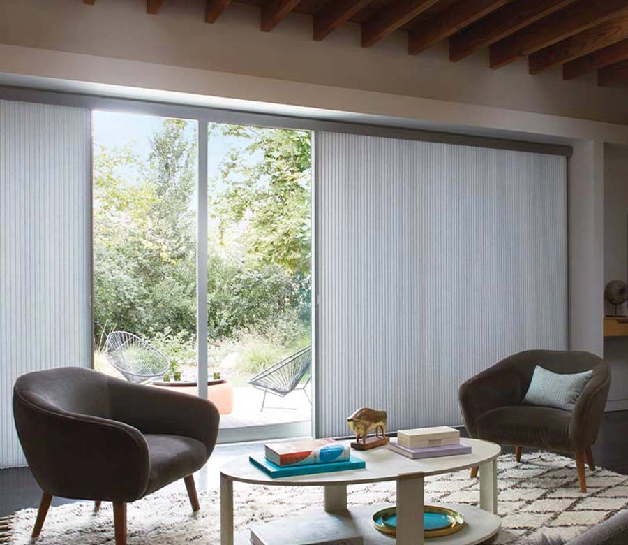 Duette® Vertiglide™ honeycomb shades on sliding glass doors in a bright living space