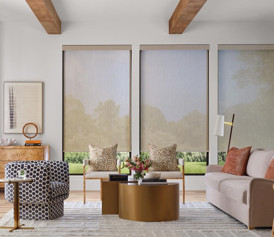 three large windows with screen shades diffusing light in living room