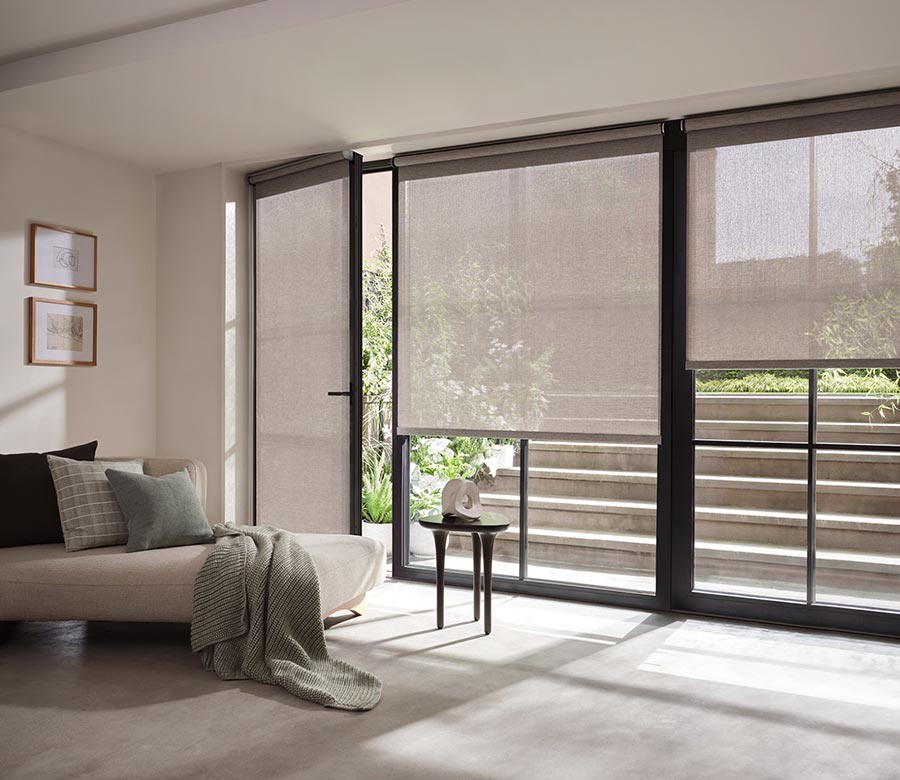 gray screen shades in living room on large windows