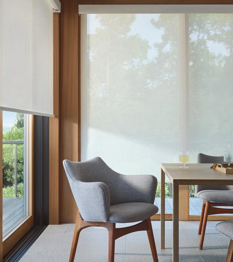 dining room that has floor to ceiling screen window coverings