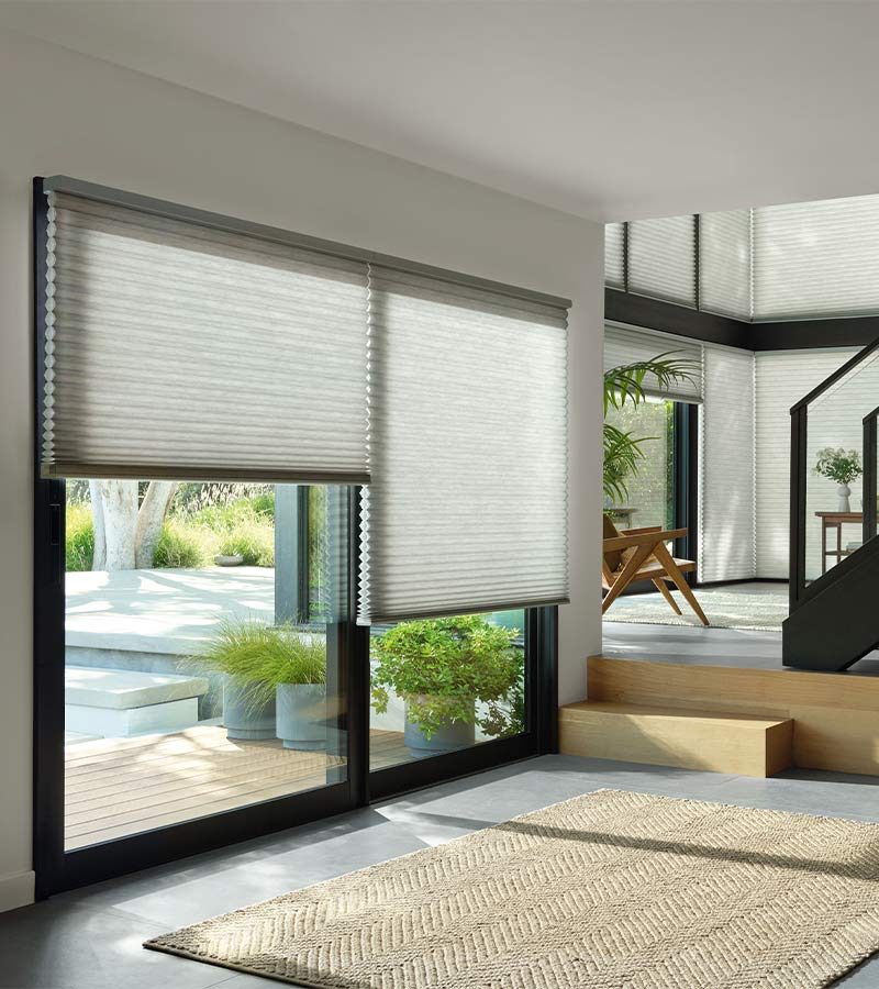 large floor to ceiling honeycomb shades for living room and staircase