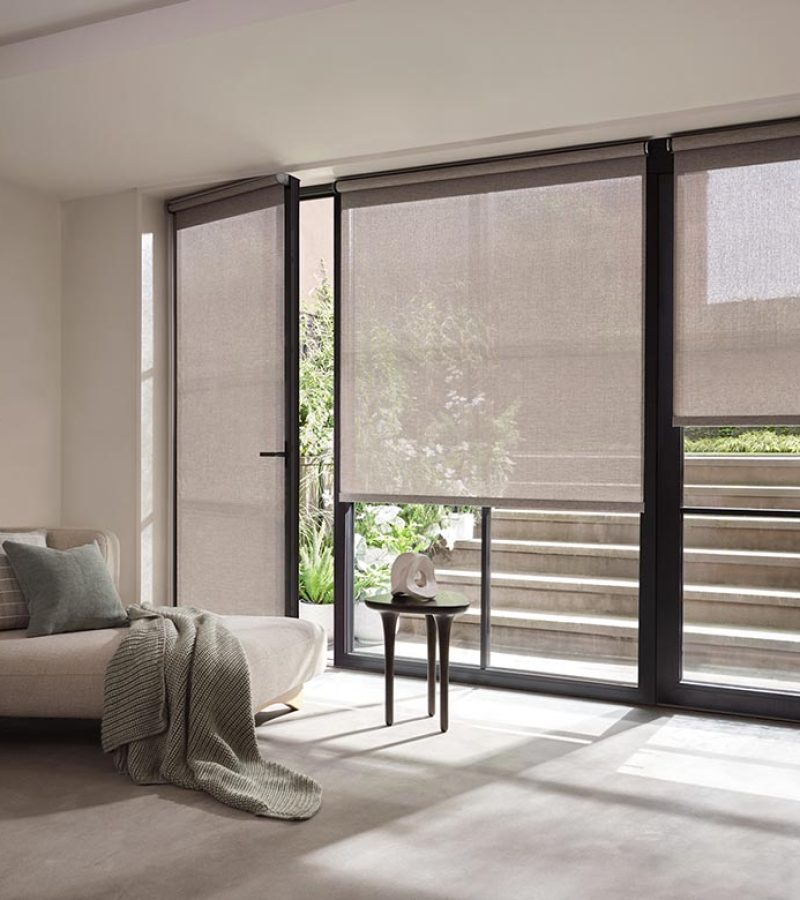 gray screen shades in living room on large windows
