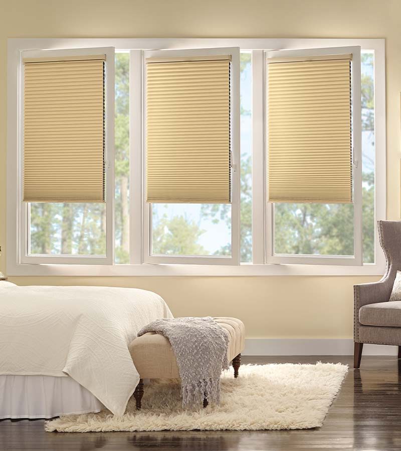 bedroom with cream tilt and turn honeycomb window shades