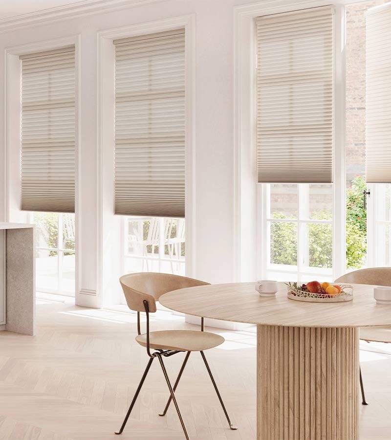 dining area with tilt and turn window coverings on door doors