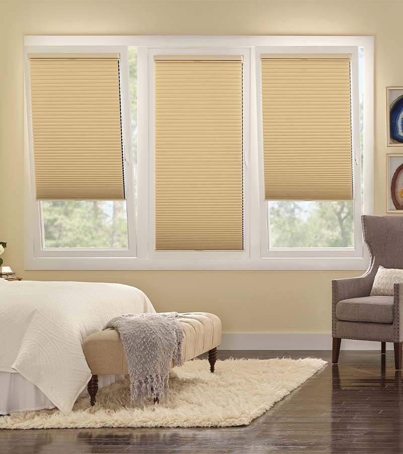 guest bedroom with cream tilt and turn window treatments on European windows